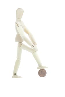 Isolated Manikin Standing On A Coin Royalty Free Stock Image