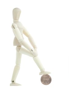 Manikin Standing On A Coin Royalty Free Stock Photography