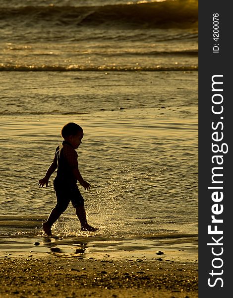 Boy playing in the waves. Boy playing in the waves