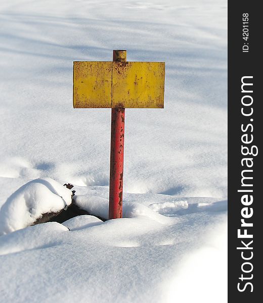 Old yellow rusty tablet on white snow background