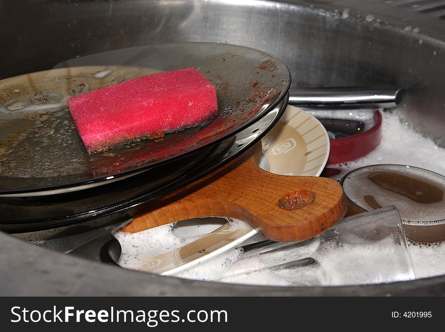 Washing dirty plates in kitchen. Washing dirty plates in kitchen