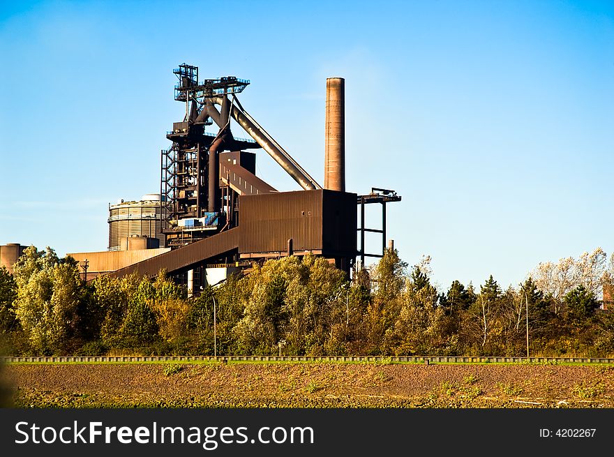 Brown coloured industrial structures with a chimney. Brown coloured industrial structures with a chimney