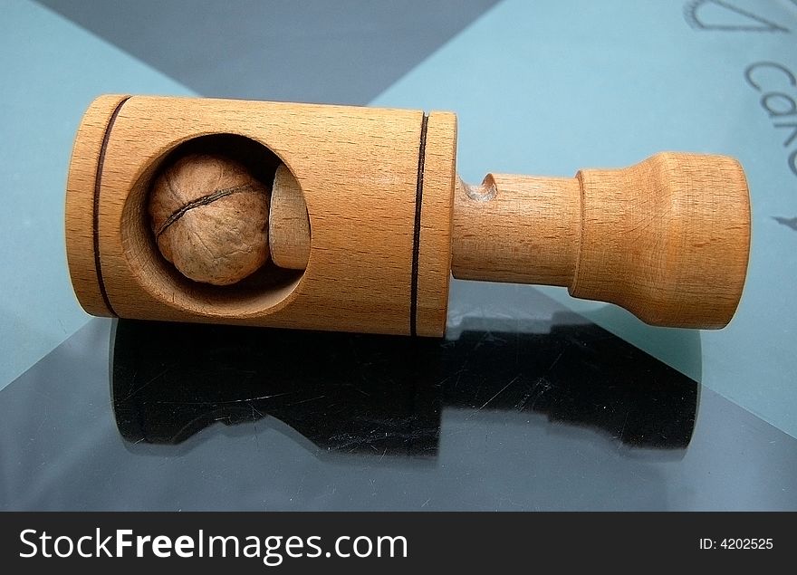 Walnuts and nutcracker on the glass plate