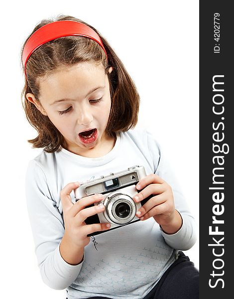 A young girl looking surprised an old camera. Isolation on white. A young girl looking surprised an old camera. Isolation on white.