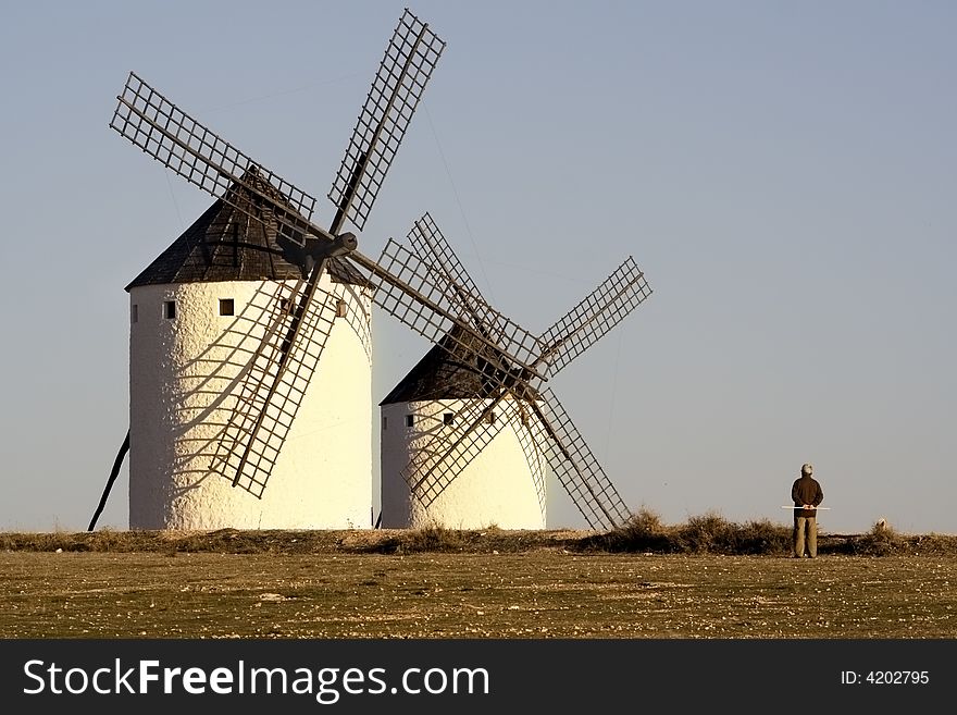 Windmills in Spain with a man watching them. Windmills in Spain with a man watching them