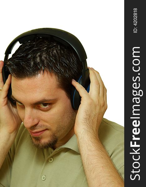 A man, wearing headphones, listening to some music. A man, wearing headphones, listening to some music
