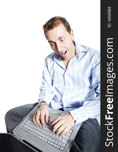 Man with surprised face using a laptop
