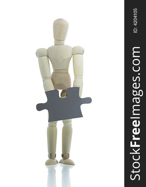 Manikin holds single black puzzle piece. Manikin holds single black puzzle piece