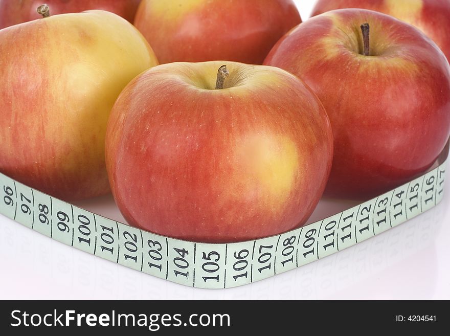 Red apples with measuring tape