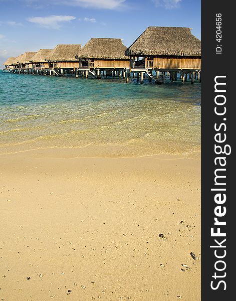 Sandy tropical beach with over the water bungalow. Sandy tropical beach with over the water bungalow