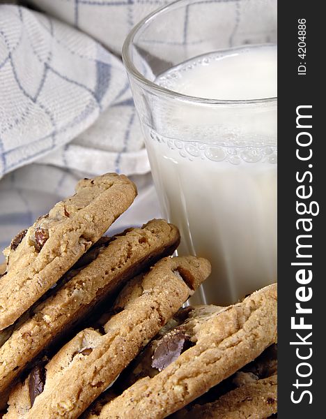 Stack of fresh chocolate chip cookies and milk.