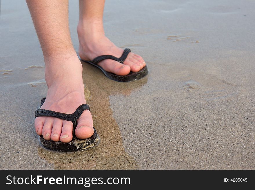 Feet with thongs on an Aussie beach. Feet with thongs on an Aussie beach.