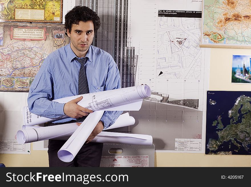 Arhitect man with papers at office