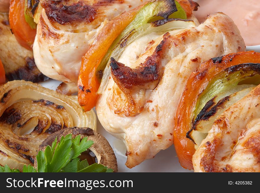 Kebab served with grilled vegetables on white plate, selective focus. Kebab served with grilled vegetables on white plate, selective focus