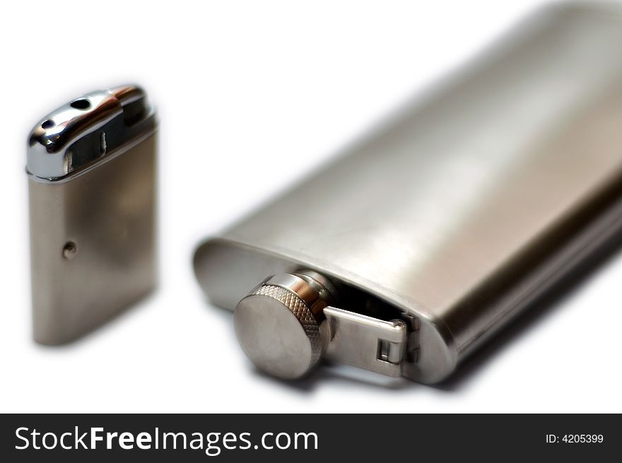 Lighter and flask on a white