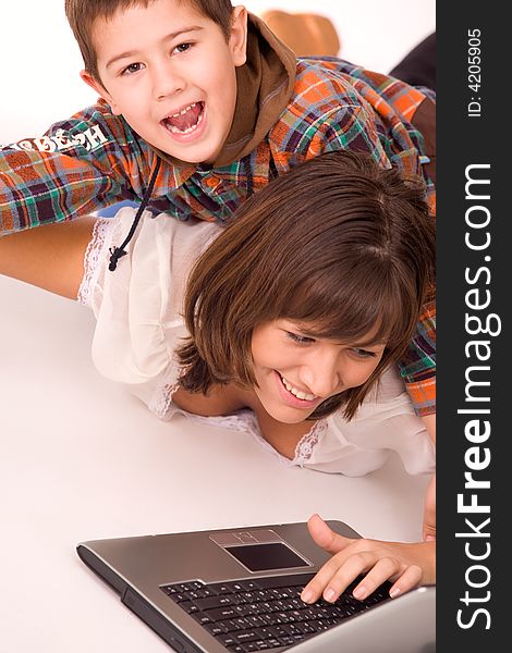 Mother and son playing with laptop over white background. Mother and son playing with laptop over white background