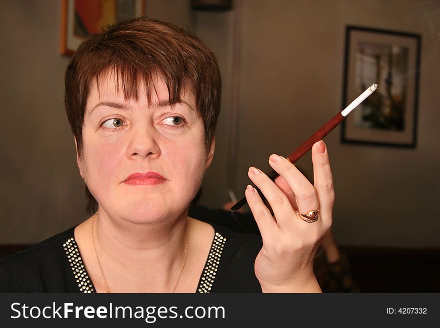 The woman with cigarette in mouthpiece