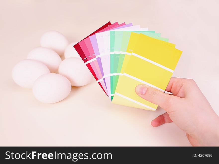 White eggs on the table and palette of colour