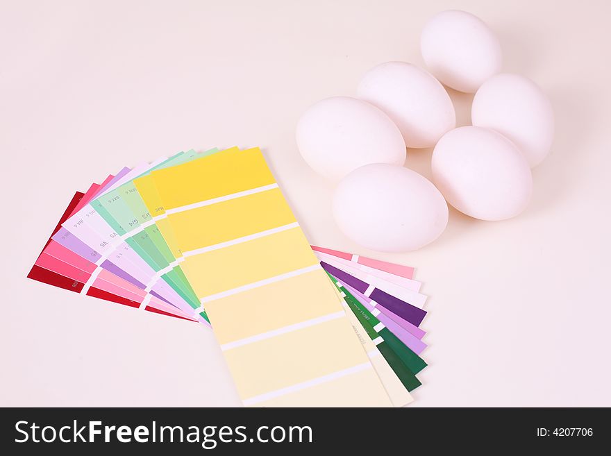 White eggs on the table and palette of colour