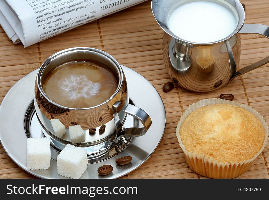 Cup of coffee with muffin and milk