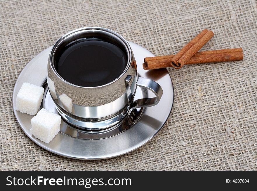 Cup of black coffee with cinnamon