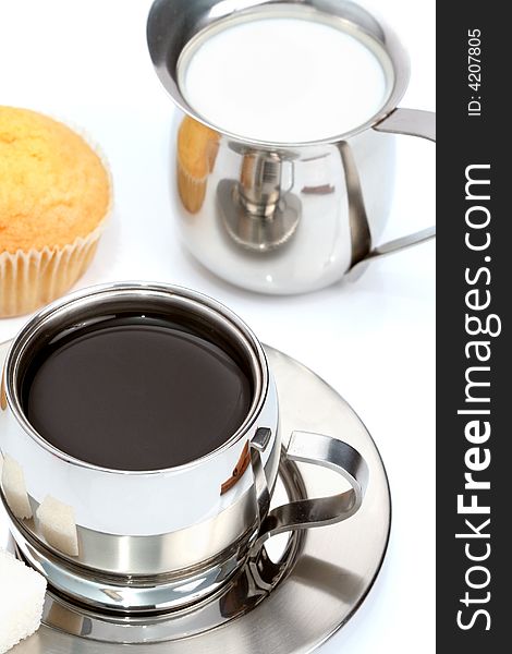 Cup of black coffee with muffin and milk