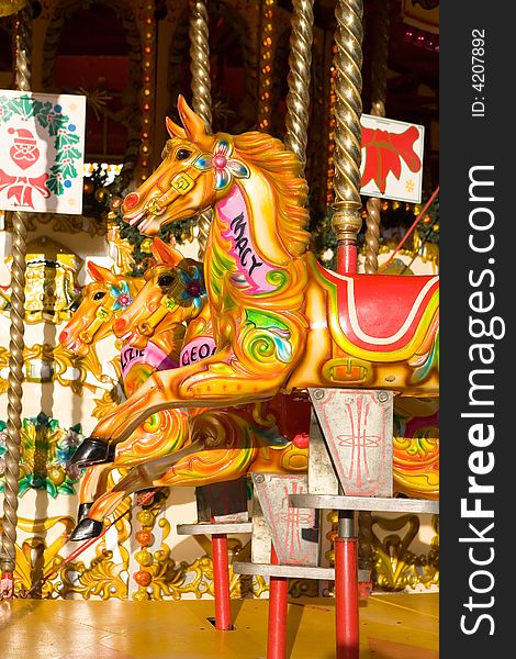Carousel golden horses photo. Closeup