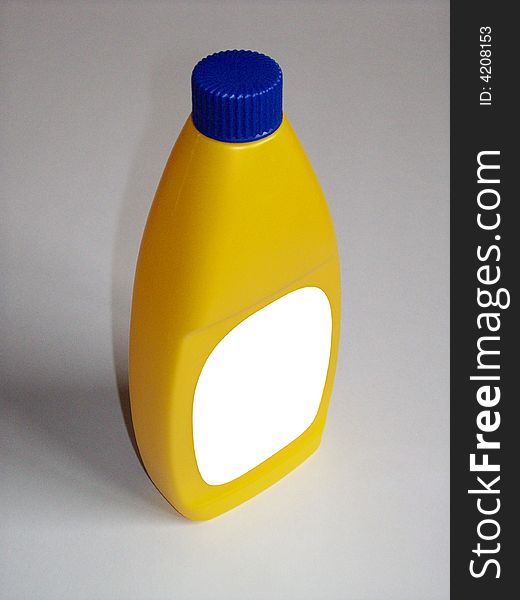 Photo of a yellow plastic bottle with the label blanked out. Photo of a yellow plastic bottle with the label blanked out