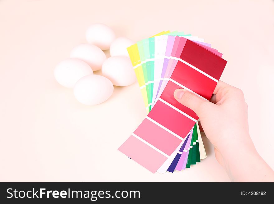 White eggs on the table and palette of colour