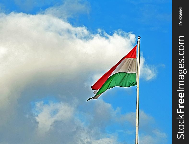 Photo of the flag at the cloudy sky background