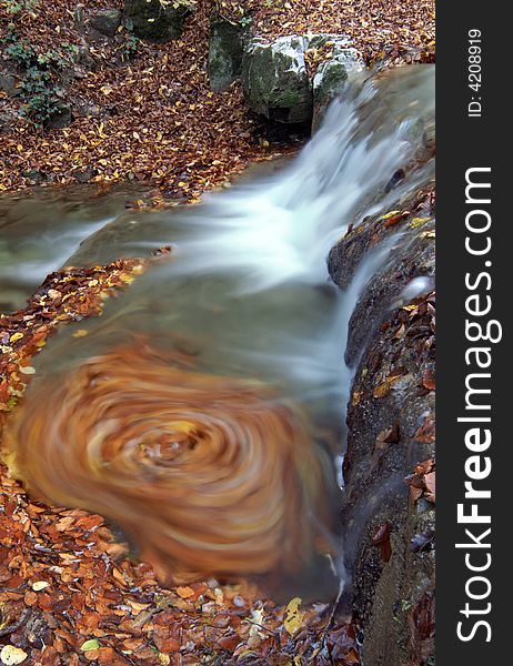 Waterfall wit whirlpool and autumn leaves. Waterfall wit whirlpool and autumn leaves