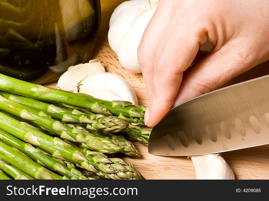 Fresh asparagus and garlic on a cutting board healthy. Fresh asparagus and garlic on a cutting board healthy