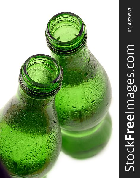 Bottled water in green, condensation-covered bottle; differential focus