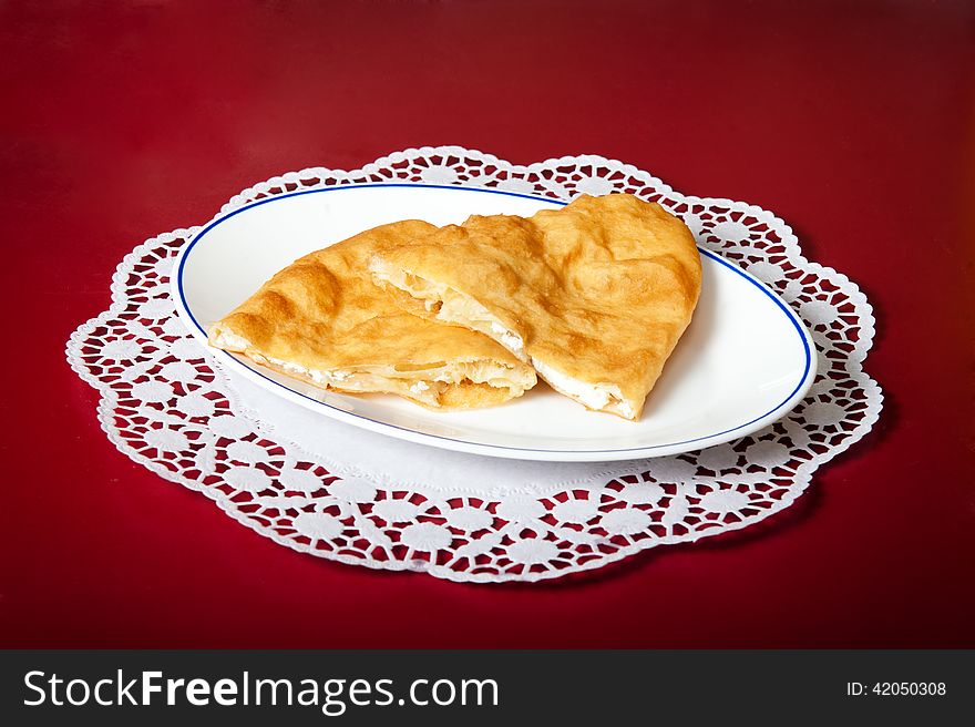 Bun with cheese on a red background.