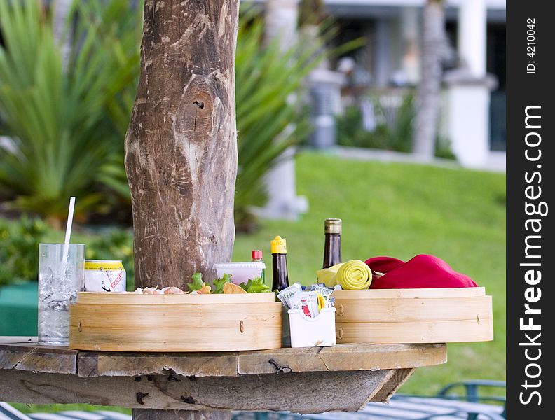 A lunch of served poolside in a luxury hotel courtyard in bamboo and rattan baskets. A lunch of served poolside in a luxury hotel courtyard in bamboo and rattan baskets