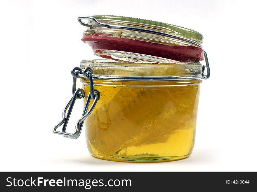 Honey and honeycomb in open kitchen jar. Honey and honeycomb in open kitchen jar