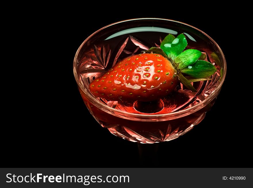 Strawberry in a drink on dark background. Strawberry in a drink on dark background