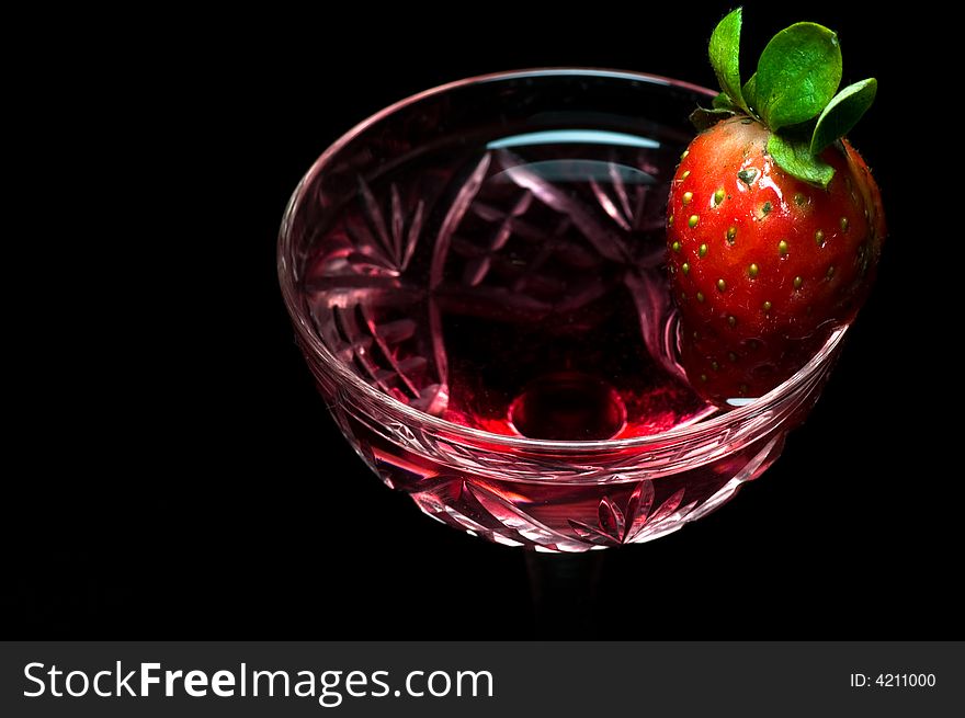 Strawberry in a drink on dark background. Strawberry in a drink on dark background