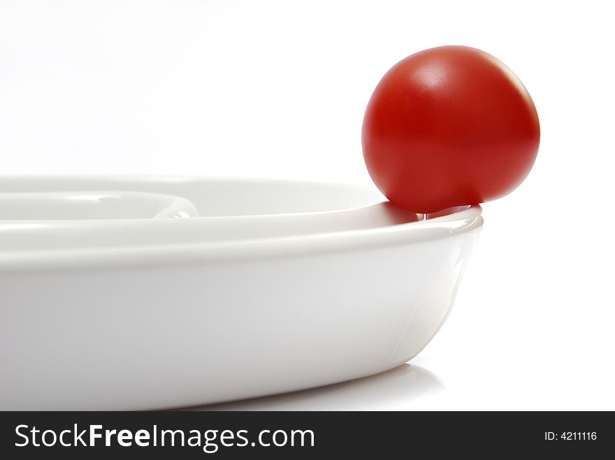 Tomato on a white plate. Tomato on a white plate