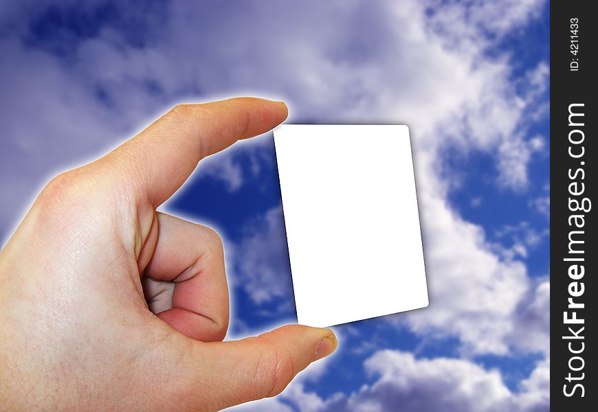 Hand holding blank card in the blue sky