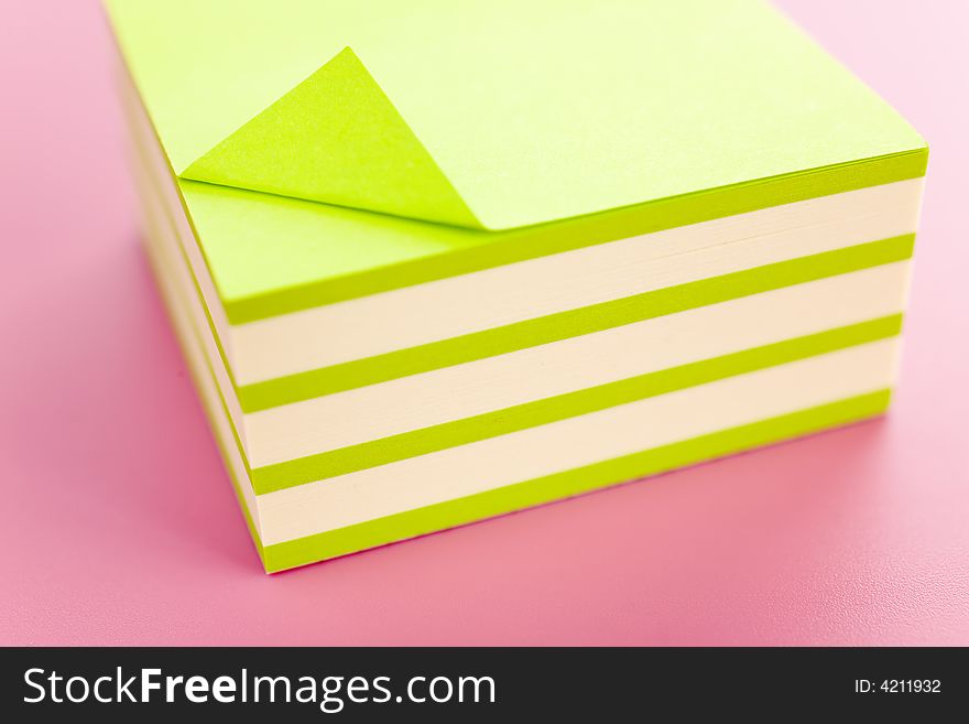 Pile of sticky notes over a pink table