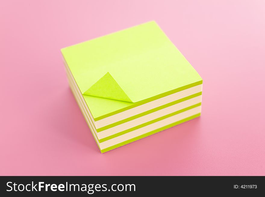 Pile of sticky notes over a pink table