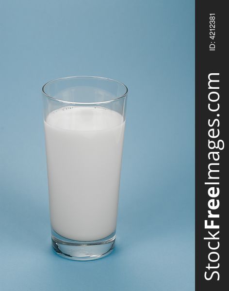 Glass of milk on a light-blue background