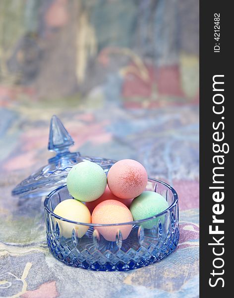 Pastel easter eggs in blue cut crystal candy dish. Pastel easter eggs in blue cut crystal candy dish