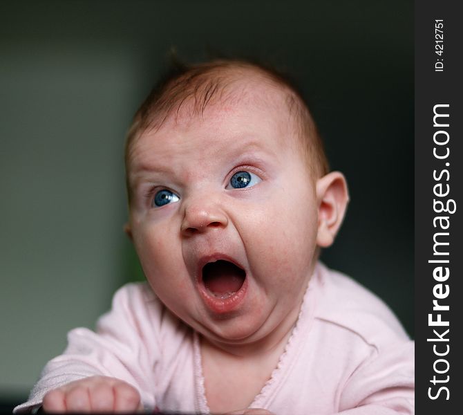 Little girl yawning on the bed. Little girl yawning on the bed