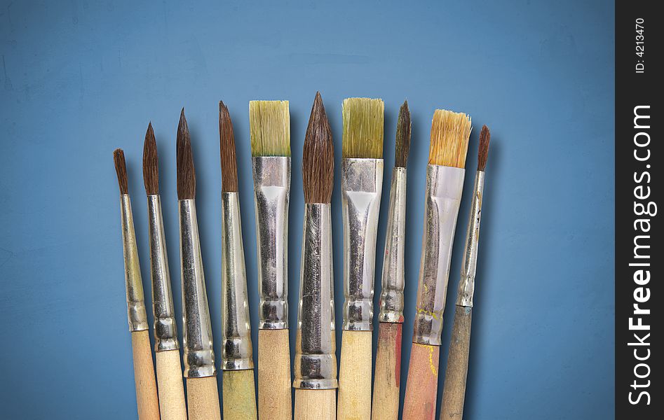 Collection of brushes on blue textured background
