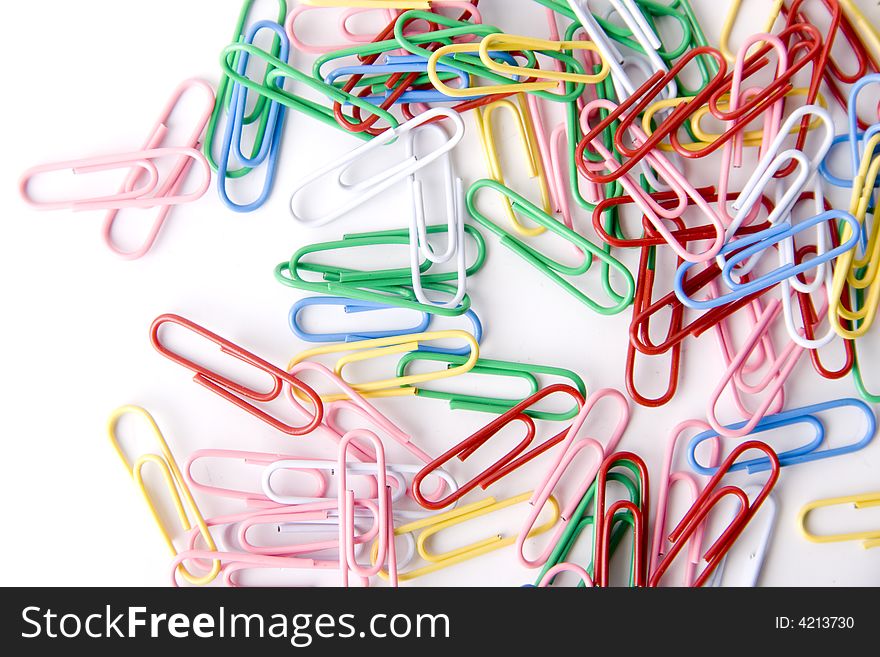 A lot of paper clips isolated on white