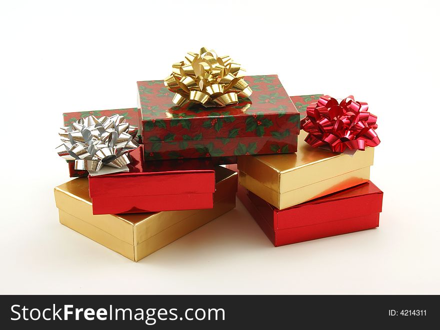 Christmas boxes, packages and presents with shiny bows on white background. Christmas boxes, packages and presents with shiny bows on white background.