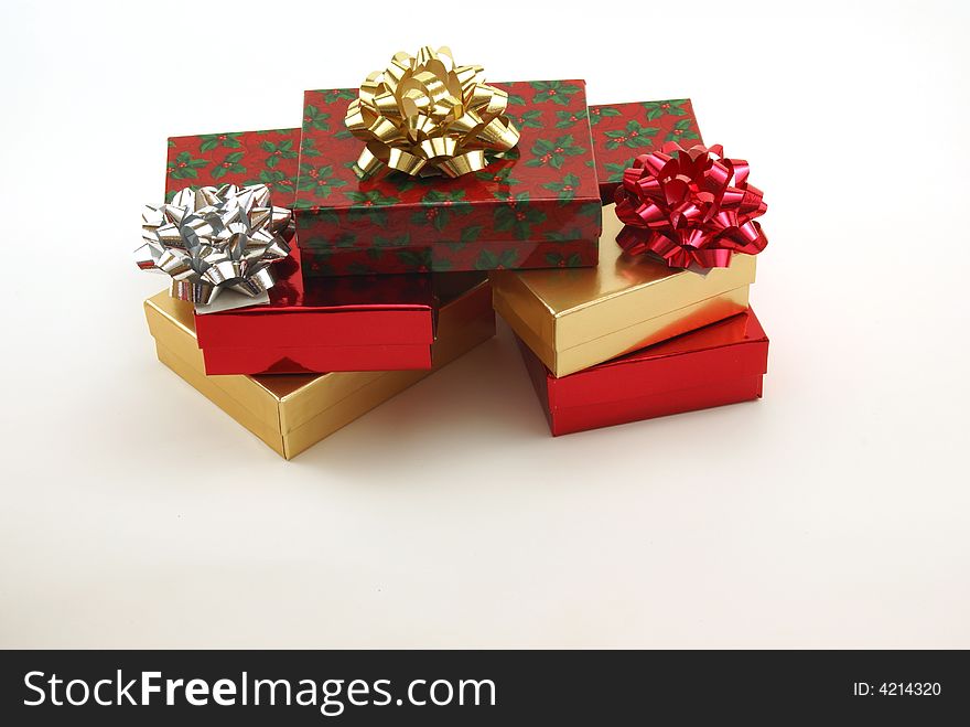 Christmas boxes, packages and presents with shiny bows on white background. Christmas boxes, packages and presents with shiny bows on white background.