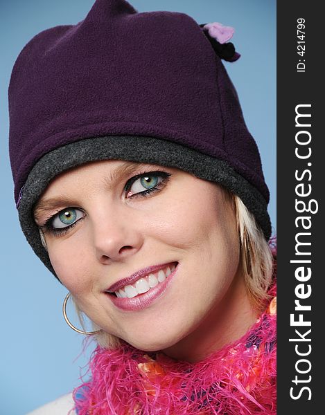 Beautiful girl with winter hat on a blue background
